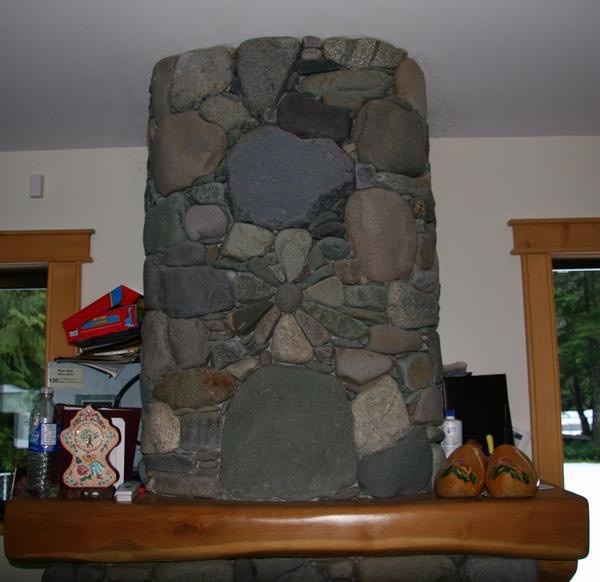 River rock chimney with a radial flower medallion detail