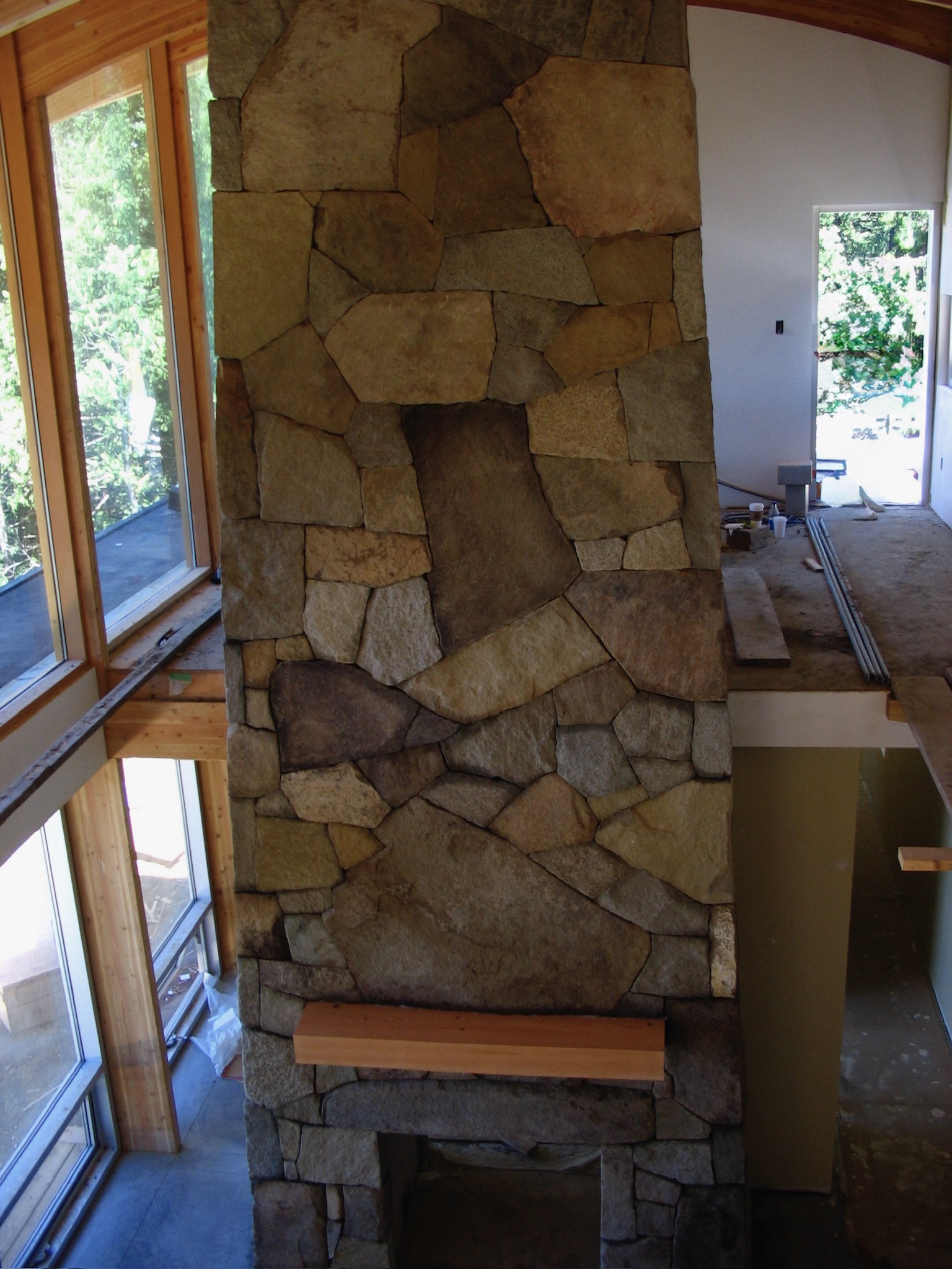 Tall flagstone fireplace column with an arched niche