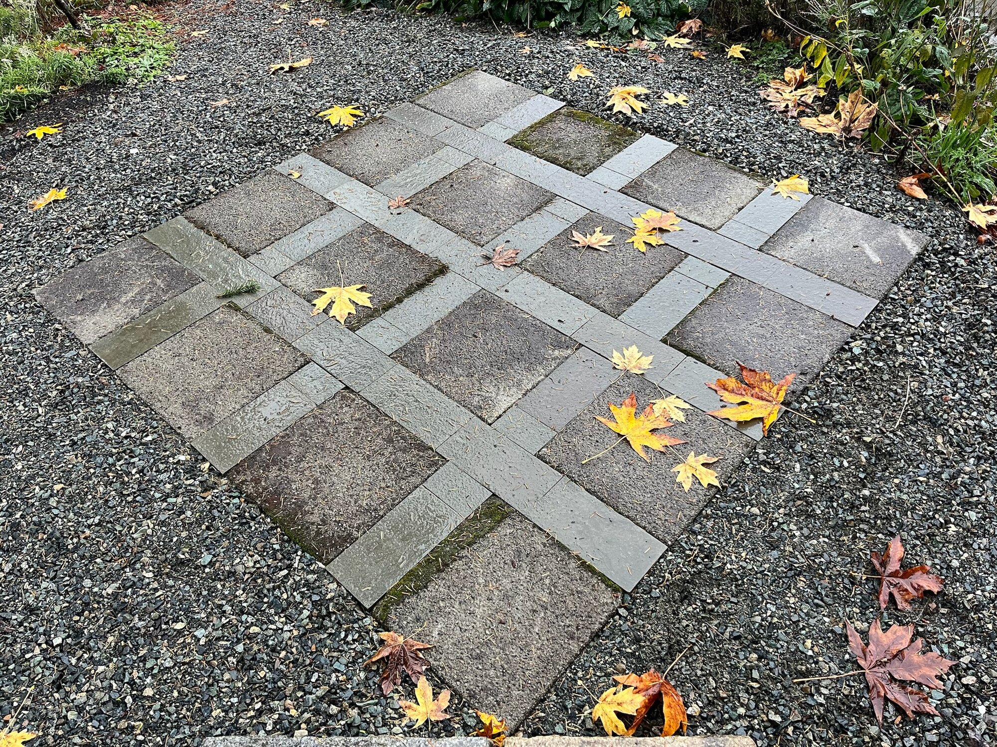 Granite stepping stones in a diamond basket-weave pattern, autumn leaves