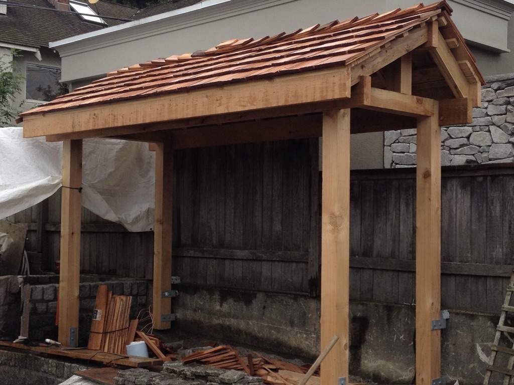 Cedar-shingled outdoor shelter with timber posts